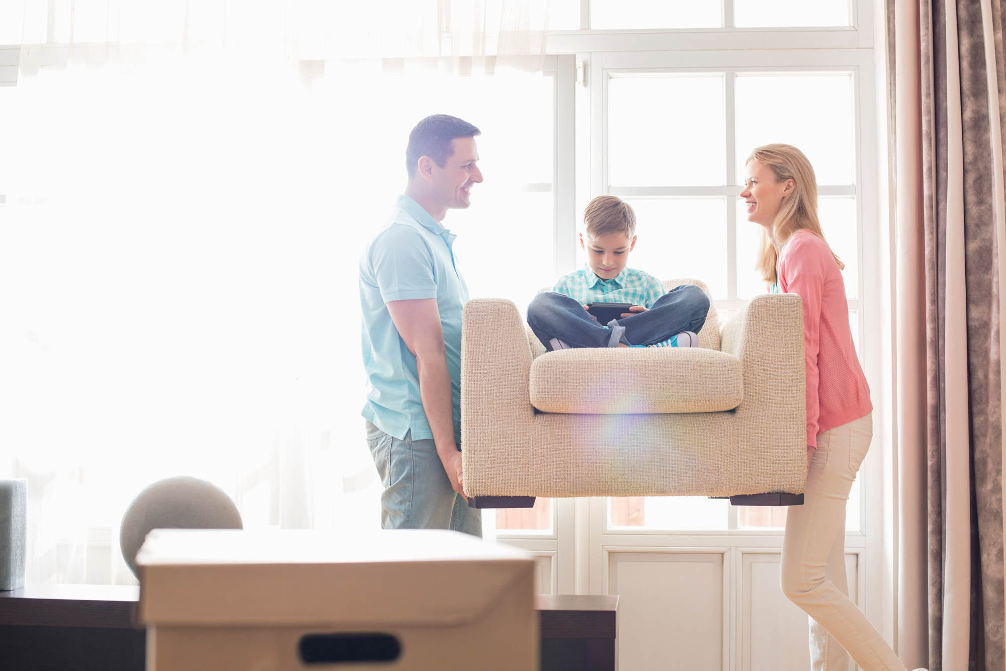 happy family moving furniture in their home 