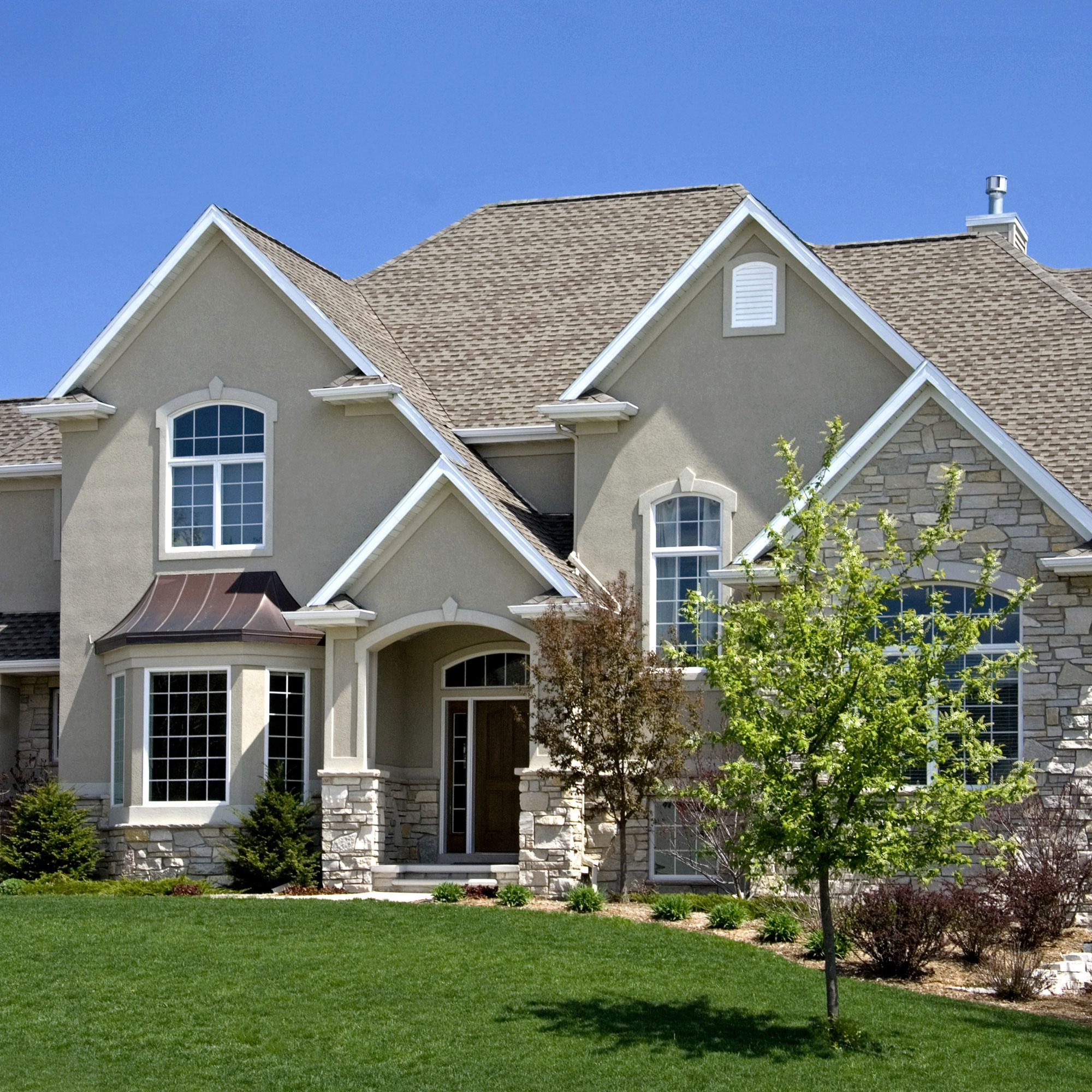 large tan house with colonial grid windows 