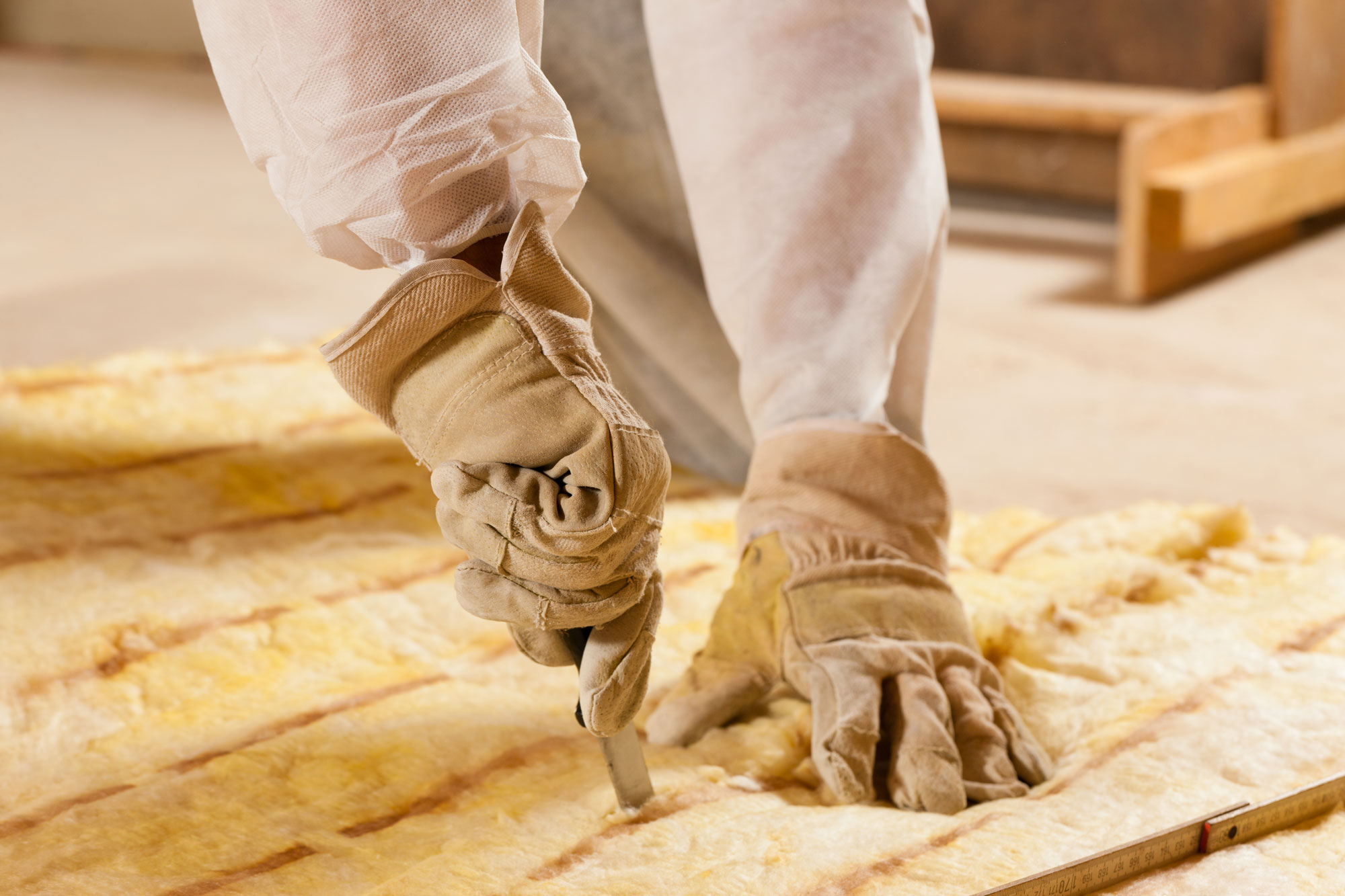 contractor cutting piece of insulation 